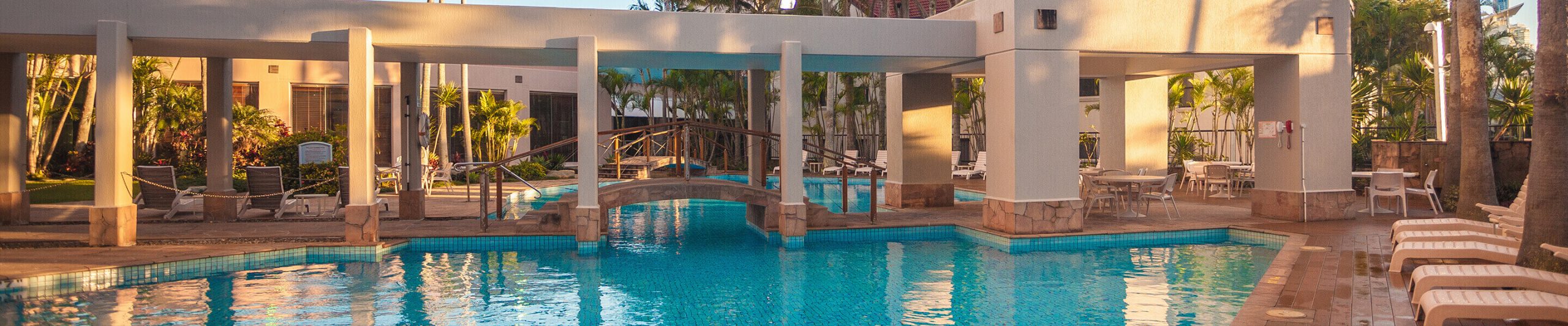 large swimming pool with bridge